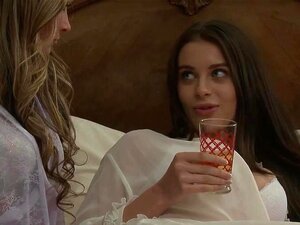 Une lesbienne blonde rejoint son amie aux gros seins sur le lit et lui