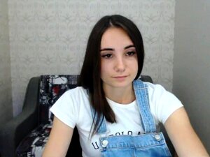 Petite brune attirante faisant un strip-tease solo
