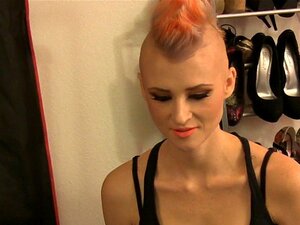 Beauté punk tatouée montrant ses faux seins en coulisses. Beauté